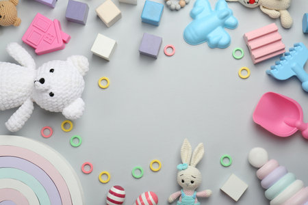 Frame of different children's toys on light gray background, flat lay. Space for textの写真素材
