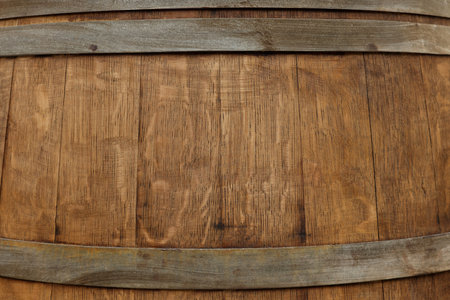 Traditional wooden barrel as background, closeup. Wine making