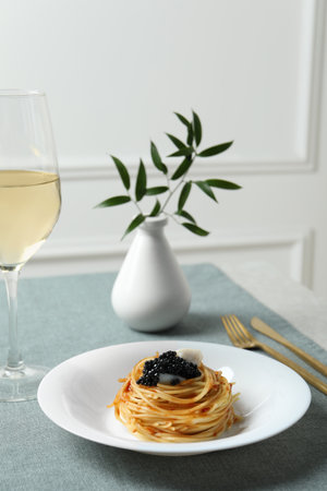 Tasty spaghetti with tomato sauce and black caviar served on table. Exquisite presentation of pasta dishの写真素材