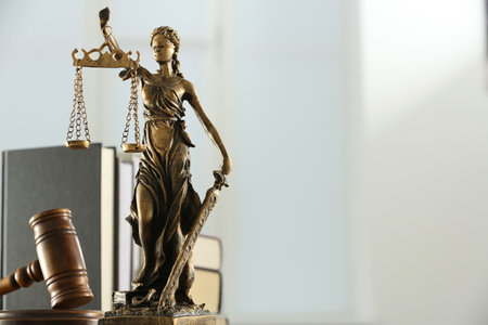 Figure of Lady Justice, gavel and books on white background, space for text. Symbol of fair...