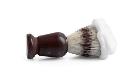 Shaving brush with foam isolated on whiteの写真素材
