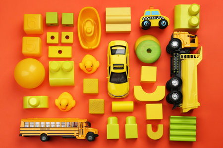 Different children's toys on orange background, flat layの写真素材