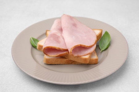 Delicious sandwich with ham on light table, closeupの写真素材