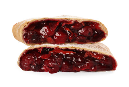 Delicious cut strudel with cherries isolated on whiteの写真素材