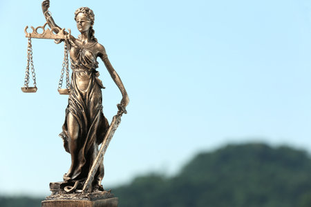 Figure of Lady Justice against sky, space for text. Symbol of fair treatment under lawの写真素材