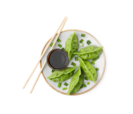 Delicious green dumplings (gyozas) and soy sauce isolated on white, top viewの写真素材