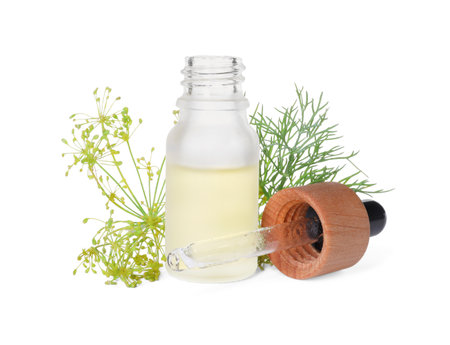 Bottle of essential oil, pipette and fresh dill isolated on whiteの写真素材