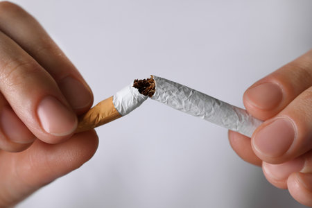 Stop smoking concept. Woman breaking cigarette, closeupの写真素材