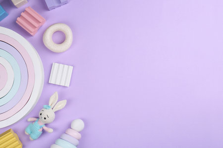 Different children's toys on violet background, flat lay. Space for textの写真素材