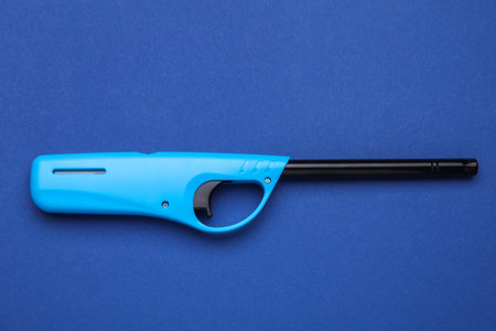 One gas lighter on blue background, top viewの写真素材