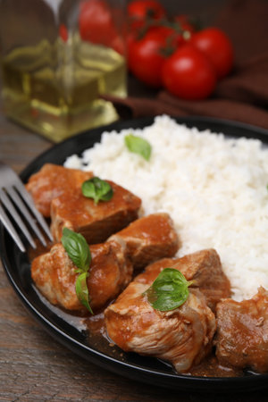 Delicious goulash served with rice on wooden table, closeupの写真素材