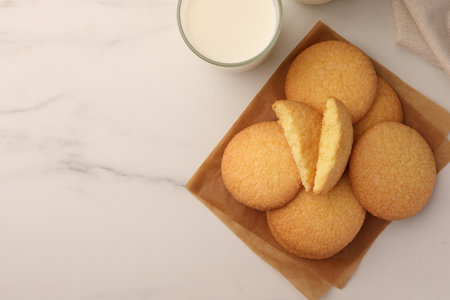 Delicious Danish butter cookies and milk on white marble table, flat lay. Space for textの写真素材