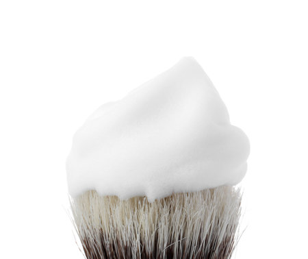 Shaving brush with foam isolated on whiteの写真素材