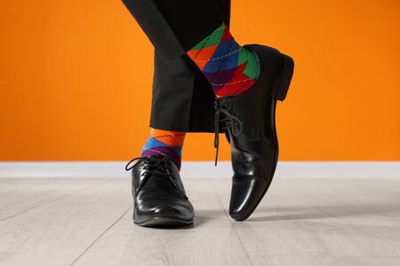 Man wearing stylish shoes and colorful socks indoors, closeupの写真素材