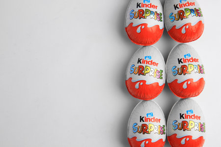 Sveti Vlas, Bulgaria - June 26, 2023: Kinder Surprise Eggs on white background, flat lay. Space for...