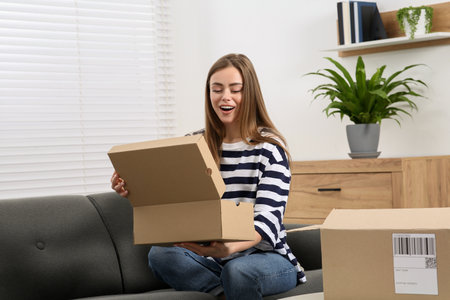 Emotional woman unpacking parcel at home. Online store
