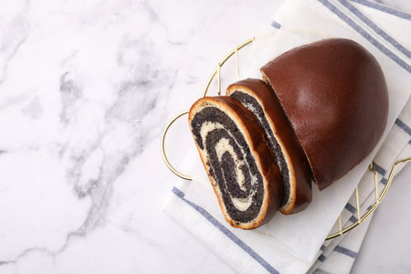 Slices of poppy seed roll on white marble table, top view with space for text. Tasty cakeの写真素材