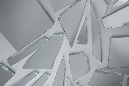 Shards of broken mirror on white background, top view