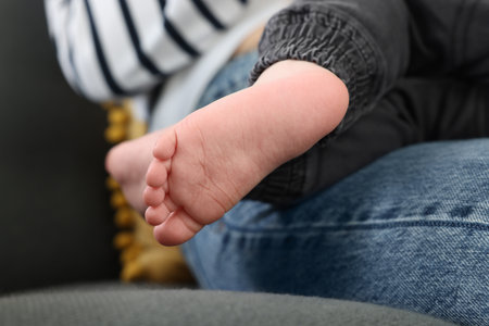 Mother resting with her son on soft sofa, closeupの写真素材