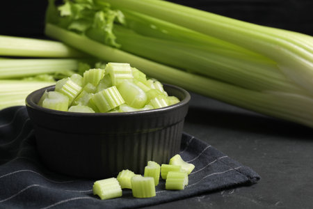 Bowl of fresh cut celery on gray table, closeupの写真素材