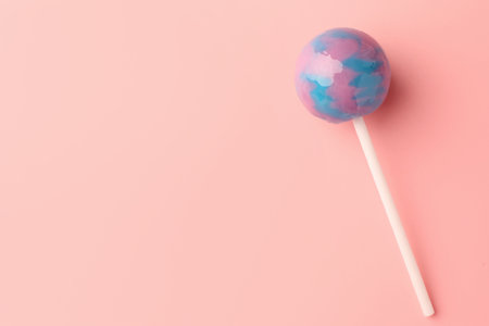 One tasty lollipop on pink background, top view. Space for textの写真素材