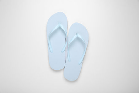Light blue flip flops on white background, top viewの写真素材