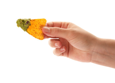 Woman holding delicious nachos chip with guacamole on white background, closeupの写真素材