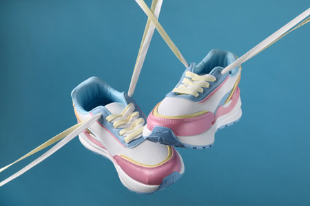 Pair of stylish sneakers on light blue backgroundの写真素材