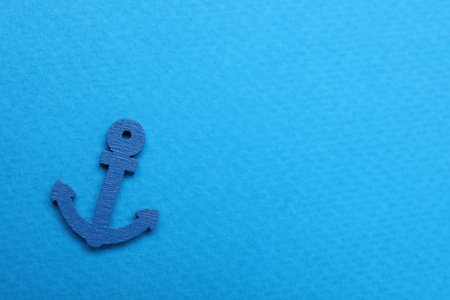 Anchor figure on light blue background, top view. Space for textの写真素材