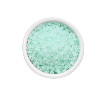 Bowl with turquoise sea salt isolated on white, top view
