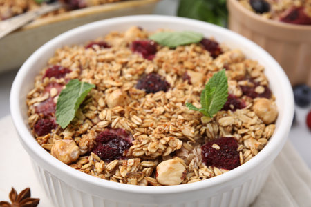 Tasty baked oatmeal with berries and nuts on table, closeupの写真素材
