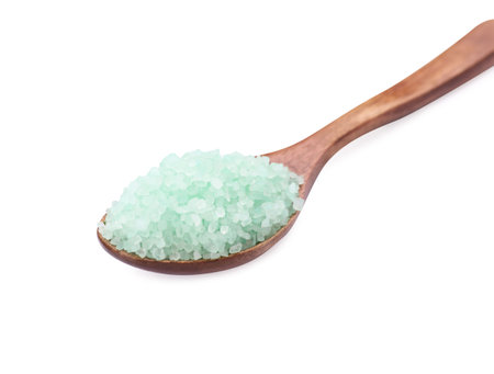 Wooden spoon with turquoise sea salt isolated on whiteの写真素材