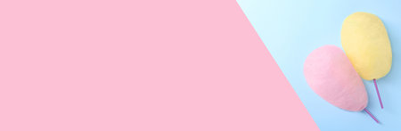 Sweet cotton candies on color background, top view. Banner design with space for text