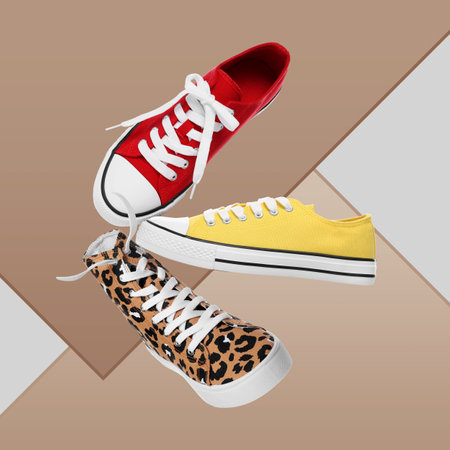 Different sneakers in air on color backgroundの写真素材