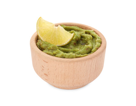 Bowl of delicious guacamole and lime isolated on whiteの写真素材