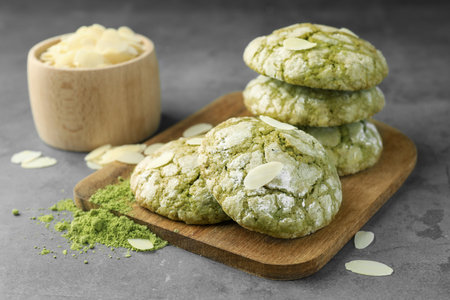 Tasty matcha cookies, almond flakes and powder on gray tableの写真素材