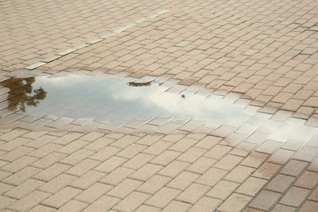 View of puddle on paving stones outdoorsの写真素材