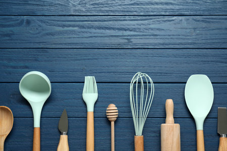 Set of different kitchen utensils on blue wooden table, flat lay. Space for textの写真素材
