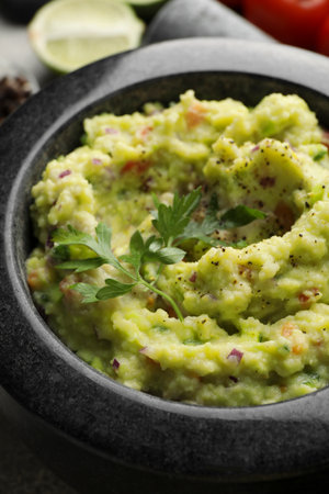 Mortar with delicious guacamole on table, closeupの写真素材