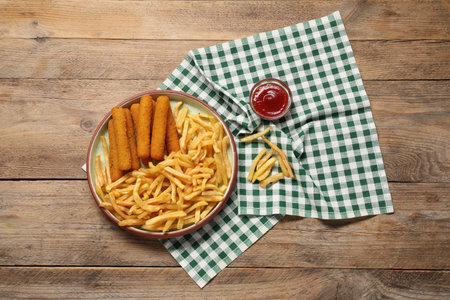 Tasty French fries, cheese sticks and ketchup on wooden table, top viewの写真素材
