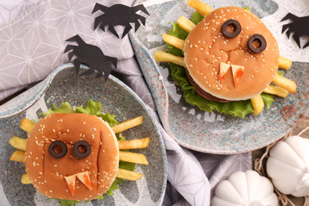 Flat lay composition with tasty monster sandwiches for Halloween party on tableの写真素材