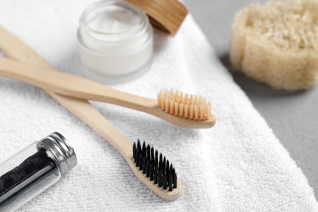 Bamboo toothbrushes, natural dental floss and towel on table, closeupの写真素材