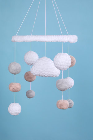 Cute baby crib mobile on light blue backgroundの写真素材