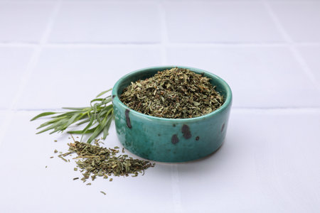 Dry and fresh tarragon on white tiled tableの写真素材