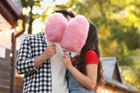 Stylish couple with cotton candies in parkの写真素材