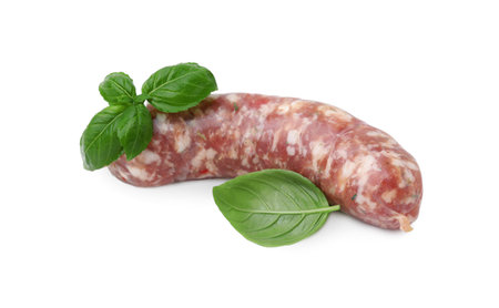 Raw homemade sausage and basil leaves isolated on whiteの写真素材