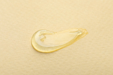 Sample of transparent gel on yellow background, closeupの写真素材