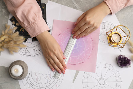 Astrologer using zodiac wheel for fate forecast at table, top view. Fortune tellingの写真素材