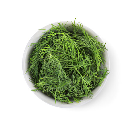Bowl of fresh dill isolated on white, top viewの写真素材