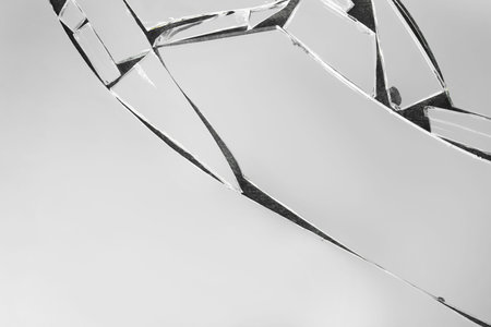 Shards of broken mirror on dark background, top view